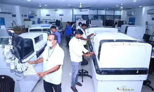 Technicians testing samples at testing lab in Sircilla