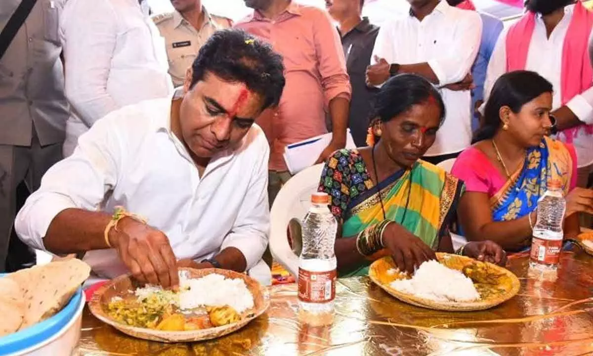 Minister KT Rama Rao having lunch with 2BHK beneficiaries in Yellareddypet mandal in Sircilla district on Tuesday
