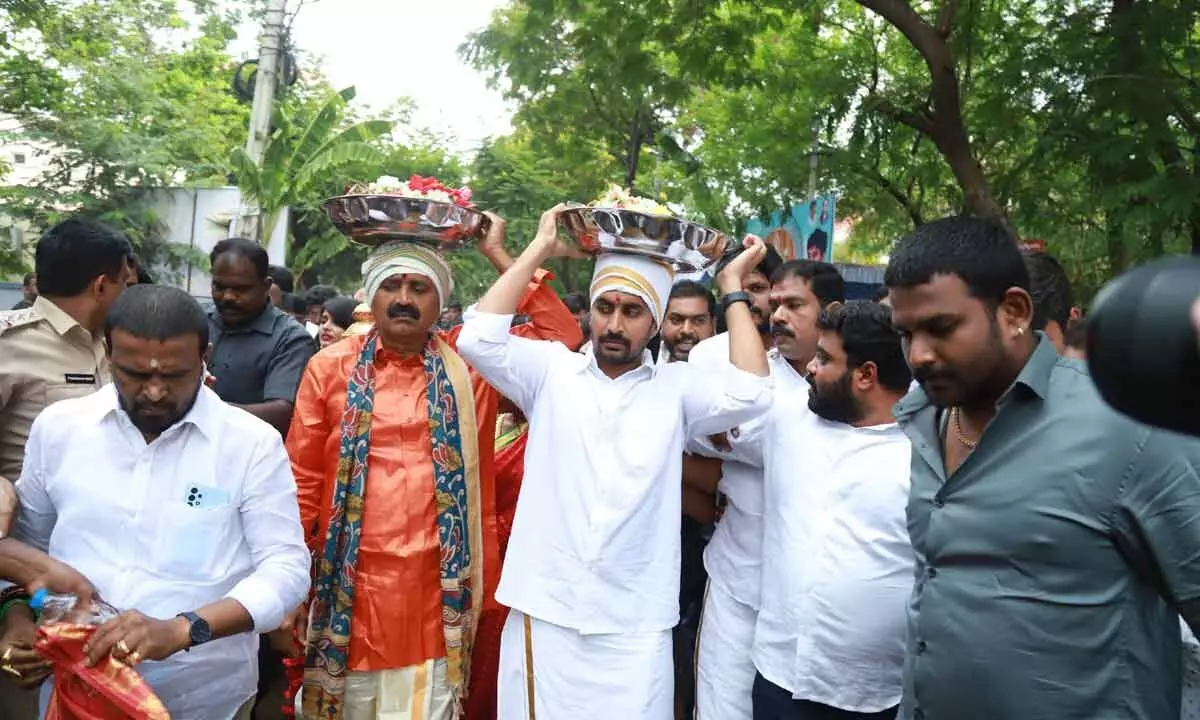 Tirupati MLA B Karunakar Reddy and Deputy Mayor Abhinay Reddy carrying Sare to Gangamma Devasthanam in Tirupati on Wednesday.