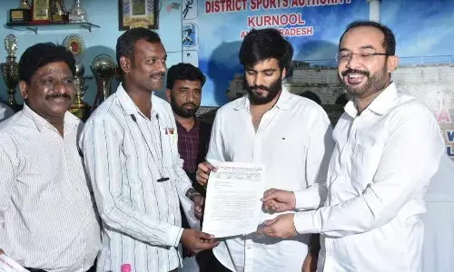 State Yoga Sports Association general secretary M Avinash Shetty submitting a representation to the Sports Authority Chairman Byreddy Siddartha Reddy in Kurnool on Wednesday. MLA MA Hafeez Khan is also seen.