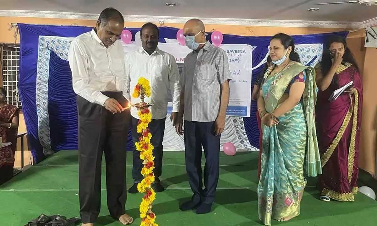KIMS Hospital Chairman Venkata Ramireddy lighting the lamp to mark the inauguration of International Nursing Day in Kurnool on Thursday. Hospital MD S V Kishore Reddy and CEO Srinivas are also seen.