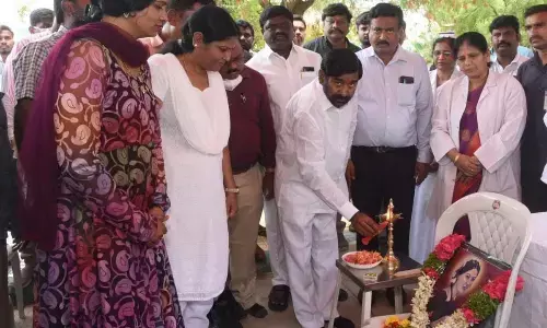 Minister Jagadish Reddy lighting the lamp during the International Nursing Day celebrations in Suryapet on Thursday