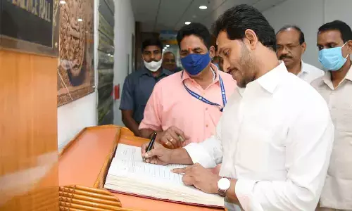 Chief Minister Jagan Mohan Reddy sings register before attending Cabinet meeting in Secretariat on Thursday