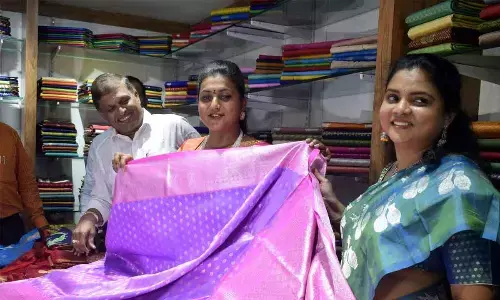 Minister for Tourism and Culture RK Roja at a summer saree mela at Apco Show Room in Vijayawada on Thursday. Apco chairman C Venkata Naga Mohan Rao and Apco Managing Director C Nagarani are also seen.	Photo: Ch Venkata Mastan