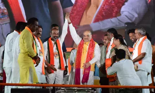 Union Home Minister Amit Shah with BJP State president Bandi Sanjay Kumar at the Tukkuguda public meeting on Saturday.  Photo: Srinivas Setty