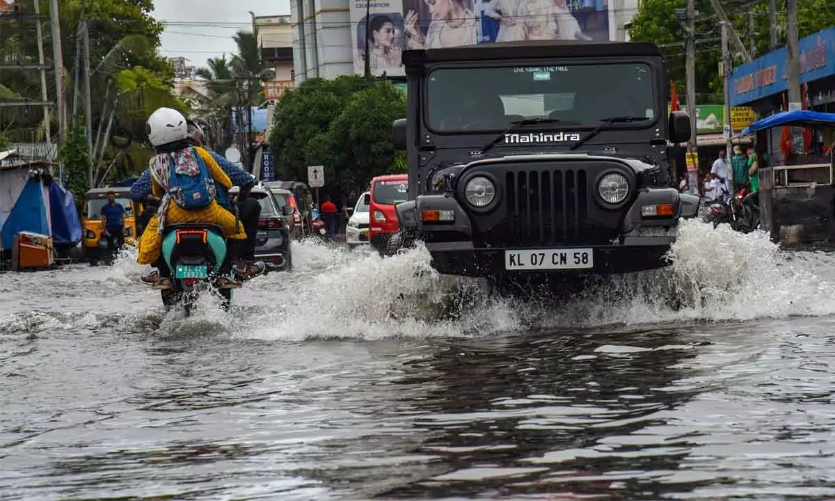Vehicles wade through a waterlogged road after heavy rain in Kochi, Sunday, May 15, 2022. Predicting extremely heavy rainfall, India Meteorological Department (IMD) has issued a red alert for 2 districts of Kerala