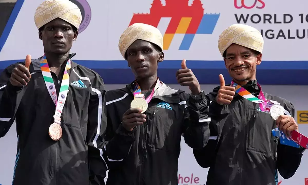 Kenyan athlete Nicolas Kipkorir Kimeli, center, winner of the TCS World 10K Bengaluru run for men, poses on podium with second placed Tadese Worku of Eithopia, right, and third placed Kibiwott Kandie of Kenya in Bengaluru. Thousands of runners participated in six different races of the 14th edition of the event