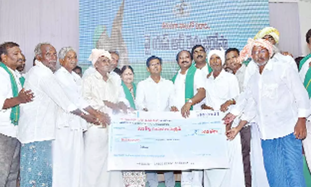 District Collector AS Dinesh Kumar, ZP Chairperson Buchepalli Venkayamma, and MLA TJR Sudhakar Babu distributing the benefits under YSR Rythu Bharosa-PM Kisan at a programme in Vellampalli village on Monday