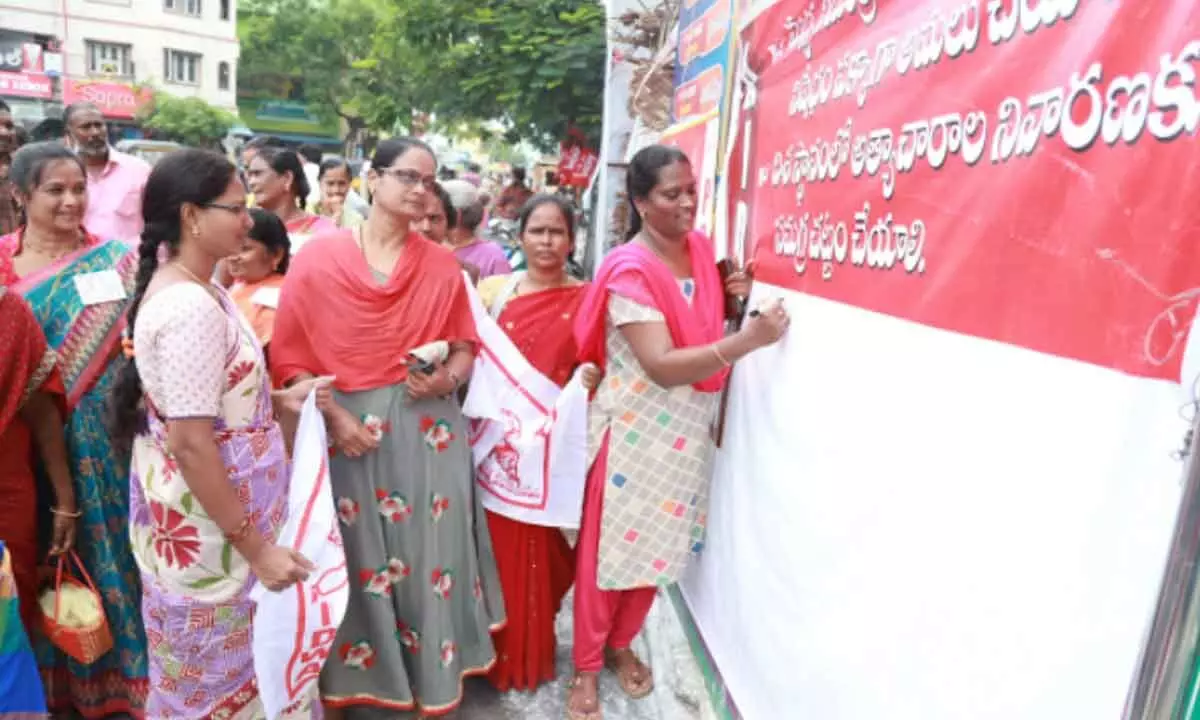 AIDWA district secretary P Sai Lakshmi inaugurating the signature campaign against the atrocities on women in Tirupati on Monday