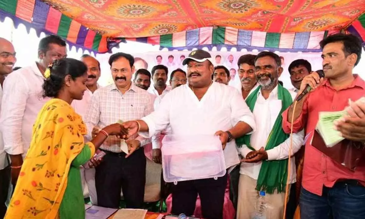 Civil Supplies Minister Gangula Kamalakar handing over double bedroom houses to beneficiaries in Makhdumpur village in Karimnagar district on Monday