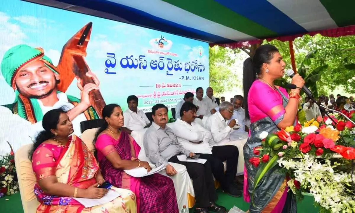Tourism Minister R K Roja addressing the Rythu Bharosa meeting at Rayalacheruvu in Ramachandrapuram mandal on Monday