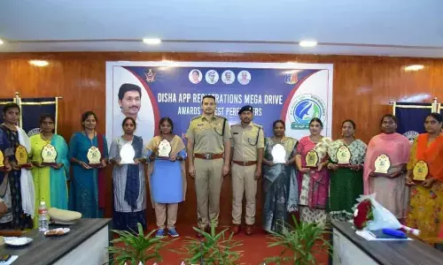 SP Siddharth Kaushal along with women police, who helped women to download Disha app, in Machilipatnam on Monday