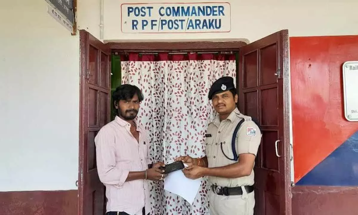 RPF personnel handing over a lost mobile phone to a complainant at Araku on Tuesday