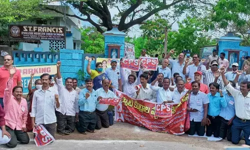 Teachers staging a protest in front of class 10 spot valuation centre in Machilipatnam on Tuesday