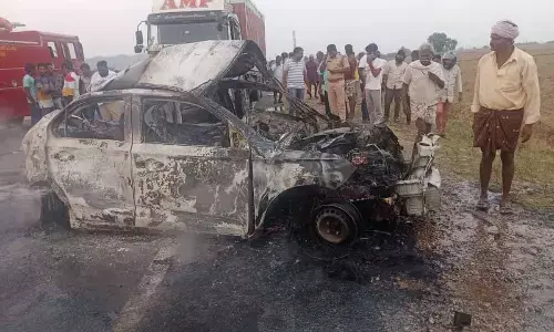 The charred remains of the car that caught fire in a mishap in Markapuram mandal on Tuesday evening