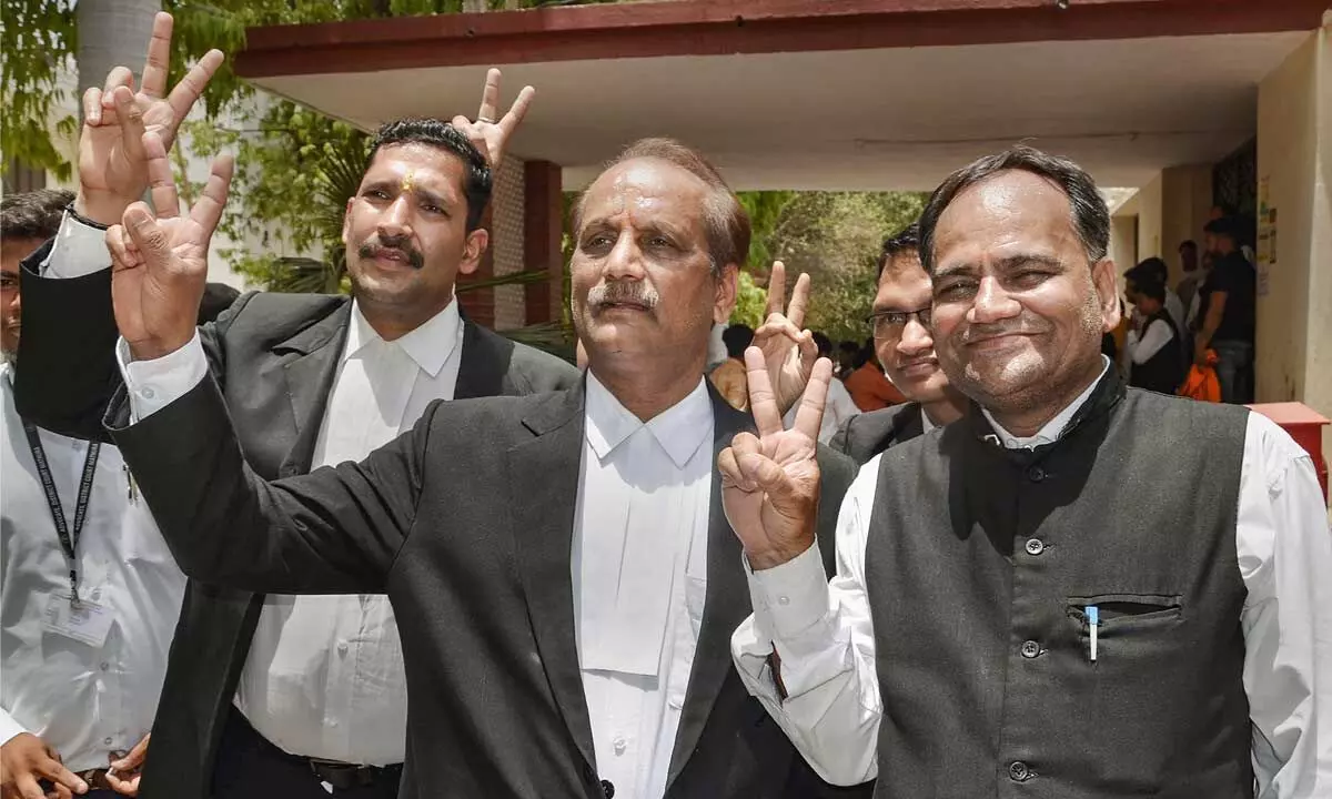 Advocates flash victory sign, at the District Court in Mathura on Thursday. The court allowed the plea by the Shri Krishna Janmabhoomi Trust and other private parties seeking ownership of the land on which the Shahi Idgah Mosque is built