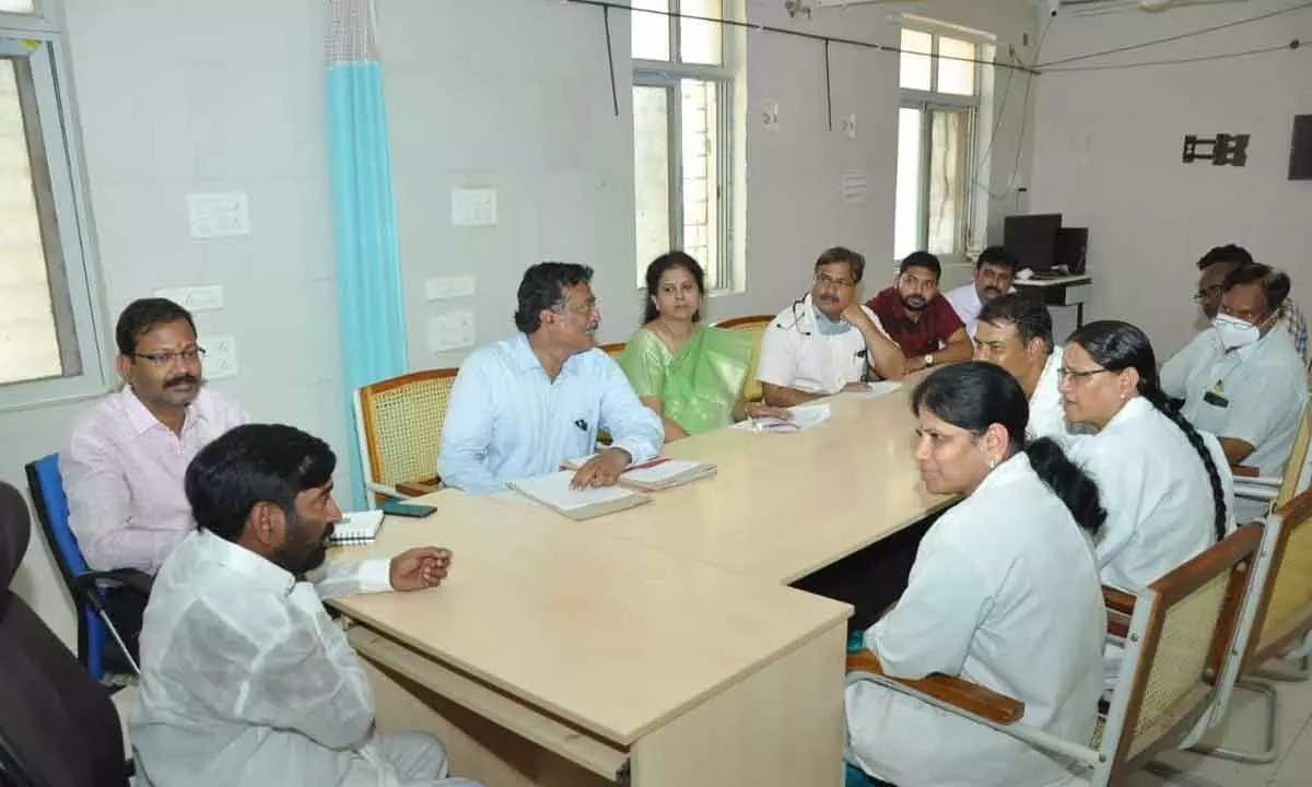 Minister Jagadish Reddy interacting with department heads during a review meeting held  at the district government hospital in Suryapet