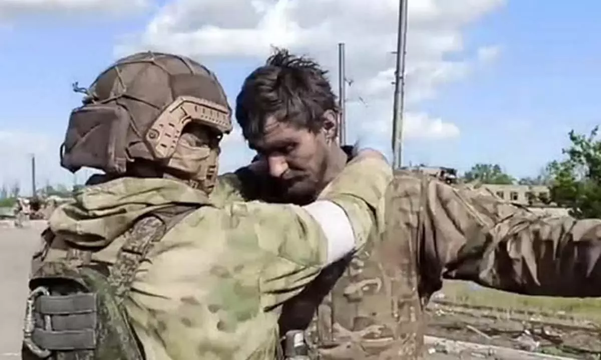 Russian serviceman frisks a Ukrainian serviceman after they leaved the besieged Azovstal steel plant in Mariupol. ( Photo | AP)