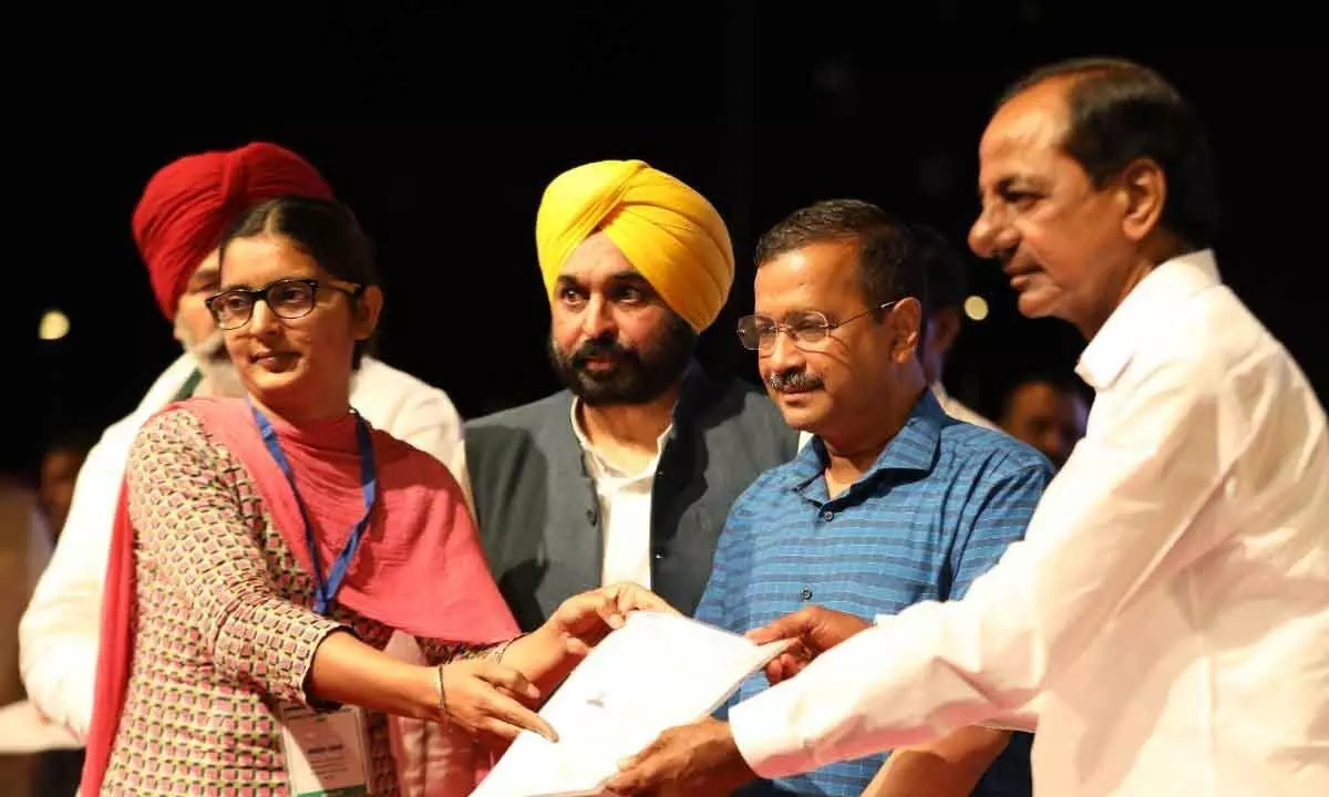 Chief Minister KCR, Delhi CM Kejriwal and Punjab CM Bhagwant Mann providing financial assistance to the kin of martyrs and farmers, who died during the protest over farm reform laws, at a function in Chandigarh on Sunday