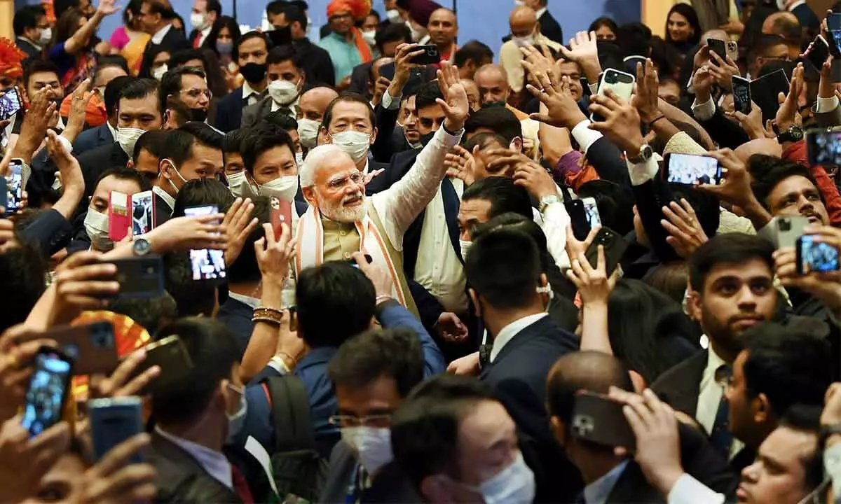 Prime Minister Narendra Modi greets members of the Indian community during an event, in Tokyo on Monday