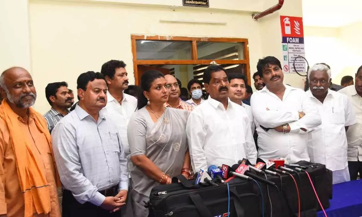 DyCM K Narayana Swamy and minister R K Roja speaking to the media in Tirupati on Tuesday. Collector K Venkata Ramana Reddy, ZP chairman G Srinivasulu, MP  Dr M Gurumoorthy, MLA B Madhusudhan Reddy and others are also seen.
