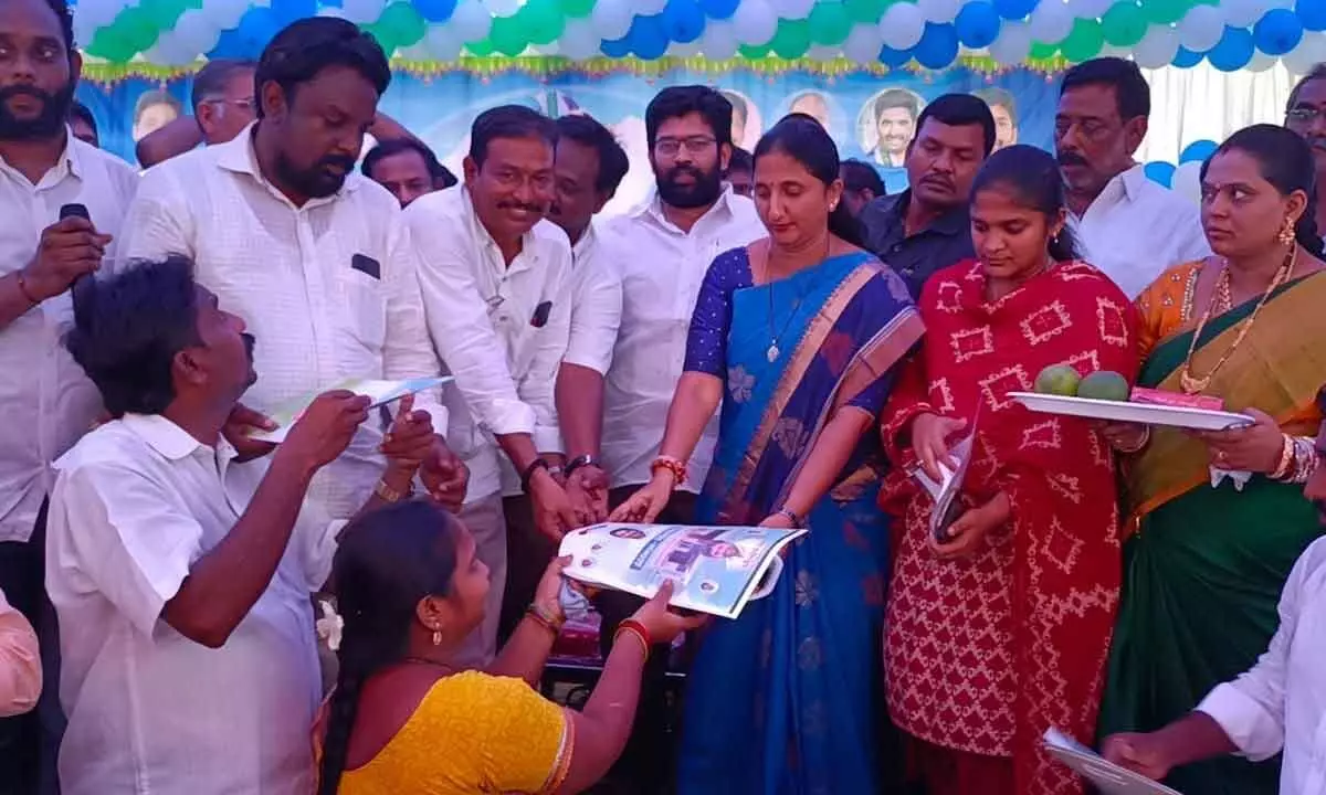 District Collector Dr K Madhavi Latha and MLA Jakkampudi Raja distributing title deeds to beneficiaries at Thokada village on Tuesday