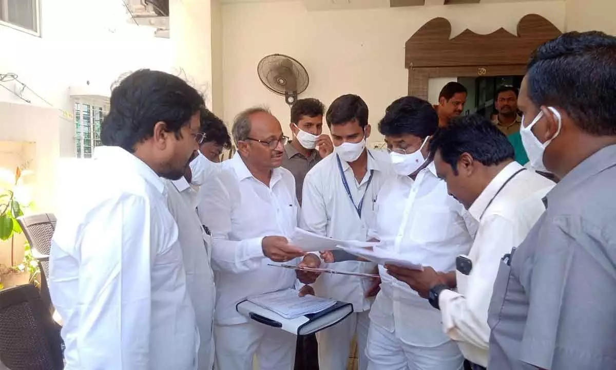Progressive Municipal Teachers Federation  president S Srinivasa Rao submitting a memorandum to Minister A Suresh at his camp office near ANU in Guntur on Tuesday