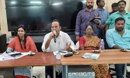 MLA A Srinivasulu speaking at a meet held in Chittoor on Thursday. Commissioner Aruna and Mayor Amuda are also seen.