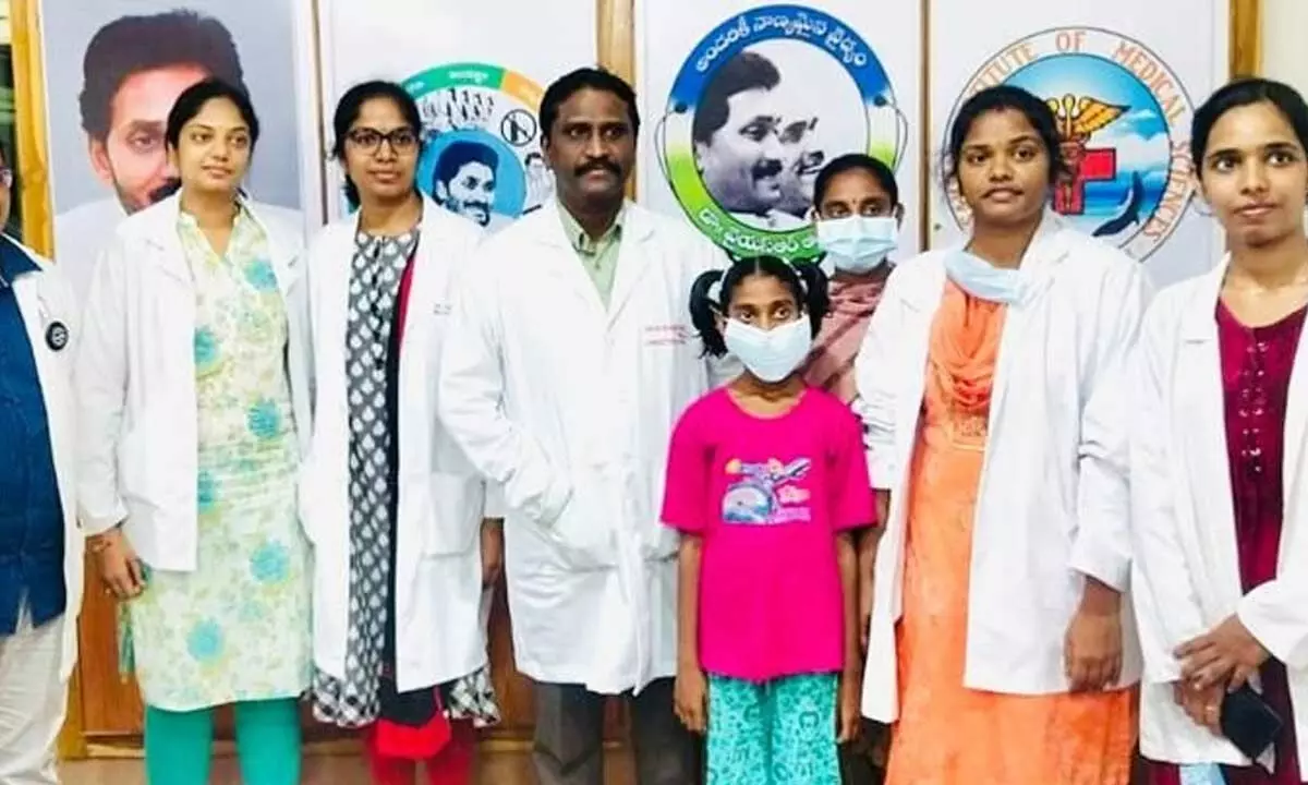 A team of doctors with a 13-year-old girl, who was treated at VIMS hospital in Visakhapatnam on Saturday