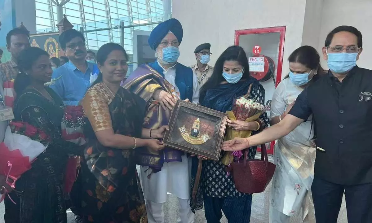 Mayor Dr R Sirisha along with MCT officials presenting Lords photo to Union Minister for Housing and Urban Affairs Hardeep Singh Puri at Renigunta airport on Saturday.