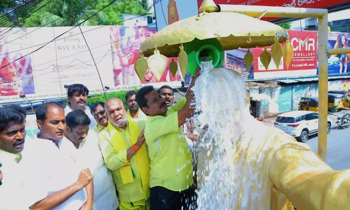 TDP leader Sridhar Varma performing Palabhishekam to the statue of NT Rama Rao in Tirupati on Saturday. Corporator RC Munikrishna is also seen.