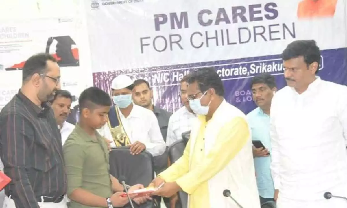 Union minister Visweswara Tudu (left) handing over postal account passbook to a child on Monday