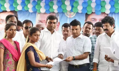 Rajampet MP P Midhun Reddy, Annamayya District Collector P S Girisha present the offer letters to youth at a mega job mela in Tamballapalle on Monday
