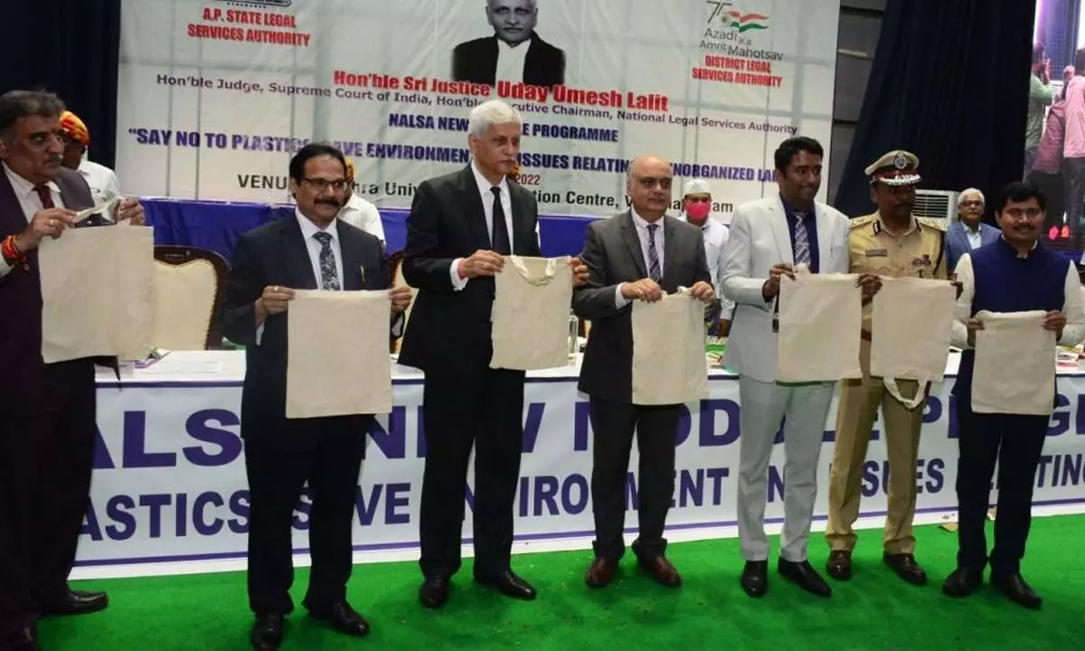 Justice Uday Umesh Lalit, Judge ,Supreme Court and  Executive Chairman of National Legal Services Authority along with others promoting eco-friendly bags to save the environment at a programme organised under the aegis of NALSA at AU Convention Centre in Vishakhapatnam