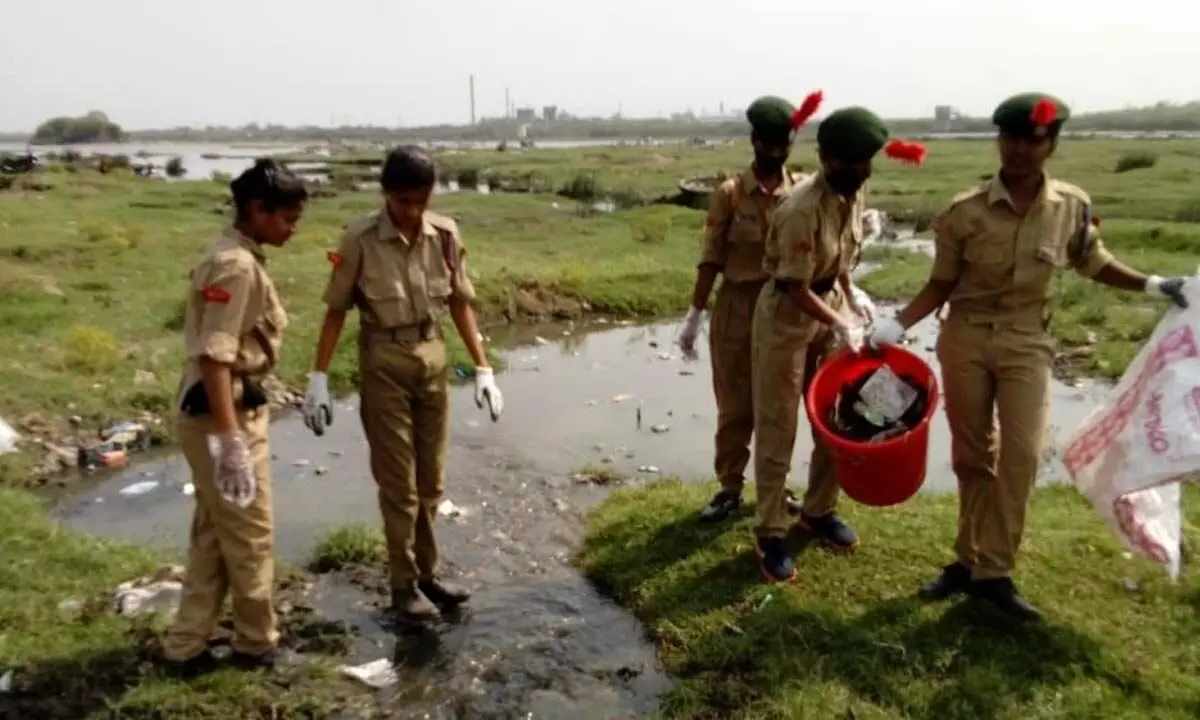The 9 Andhra Battalion girl cadet corps cleaning the garbage and collecting the plastic waste on the banks of Tungabhadra River as part Puneet Sagar Abhiyan in Kurnool on Saturday.