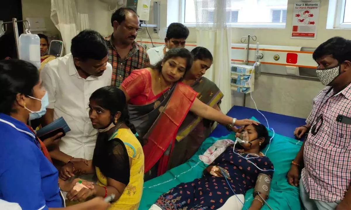 TDP women wing president V Anitha with the victims of gas leak at NTR Government Hospital in Anakapalle on Saturday