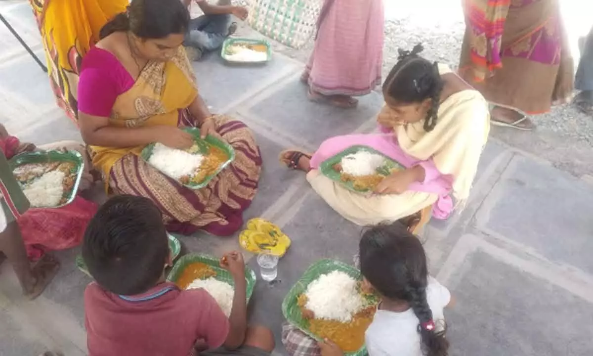 A woman and children having meals at Annagari Bhojanasala at RTO office in Guntur