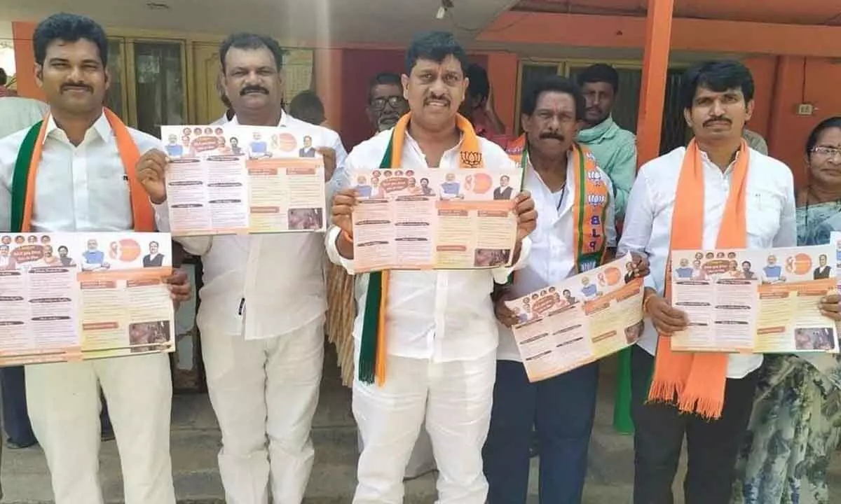 BJP district president Galla Satyanarayana and others leaders releasing handouts on the achievements of  the Modi government, in Wyra on Sunday.