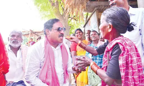 An elderly woman feeding Minister for Panchayat Raj Errabelli Dayakar Rao at Regula village under Kodakandla mandal in Jangaon district on Sunday