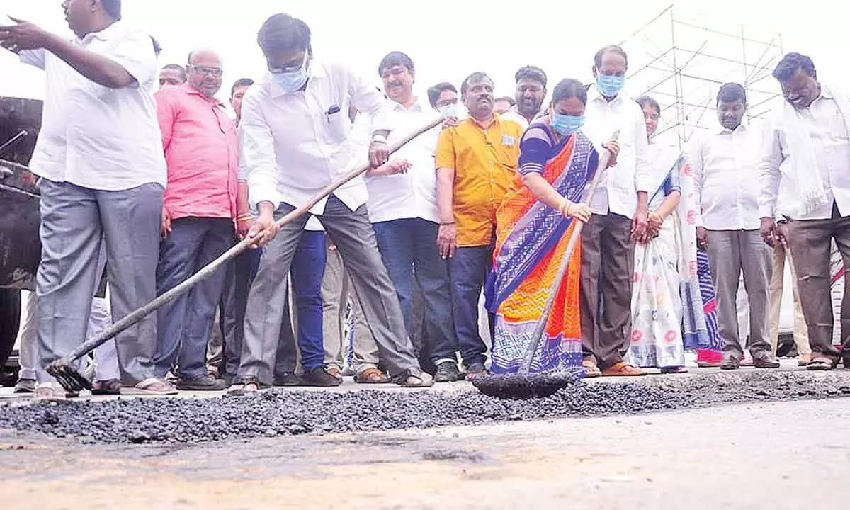 Transport Minister Puvvada Ajay Kumar taking part in the road repair works at Gandhi Chowk in Khammam town on Monday