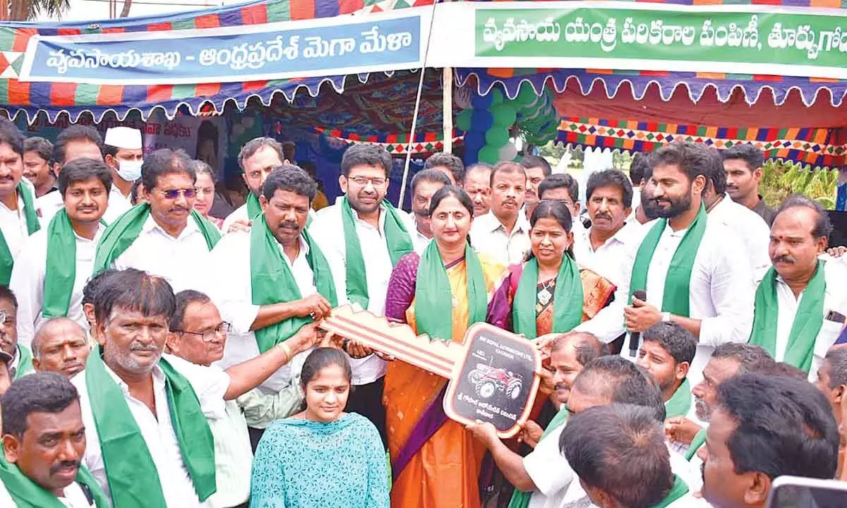 Home Minister Taneti Vanitha, District Collector Dr K Madhavi Latha and MP Bharat Ram handing over a tractor to a beneficiary after inaugurating YSR Yanthra Seva scheme in Rajamahendravaram on Tuesday