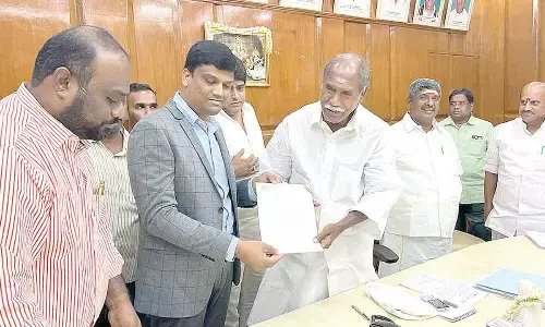 CM Pondicherry N Ramaswamy giving a supporting letter to SGES founder  N Suresh Reddy in Puducherry on Tuesday