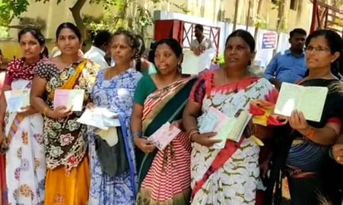 The victim women showing their savings pass books of the respective society in Miryalaguda on Wednesday