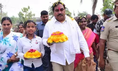 Minister for Panchayat Raj and Rural Develo pment Errabelli Dayakar Rao holding Bathukamma at the 5th phase of Palle Pragathi programme at Ramavaram village under Kodakandla mandal in Jangaon district on Thursday