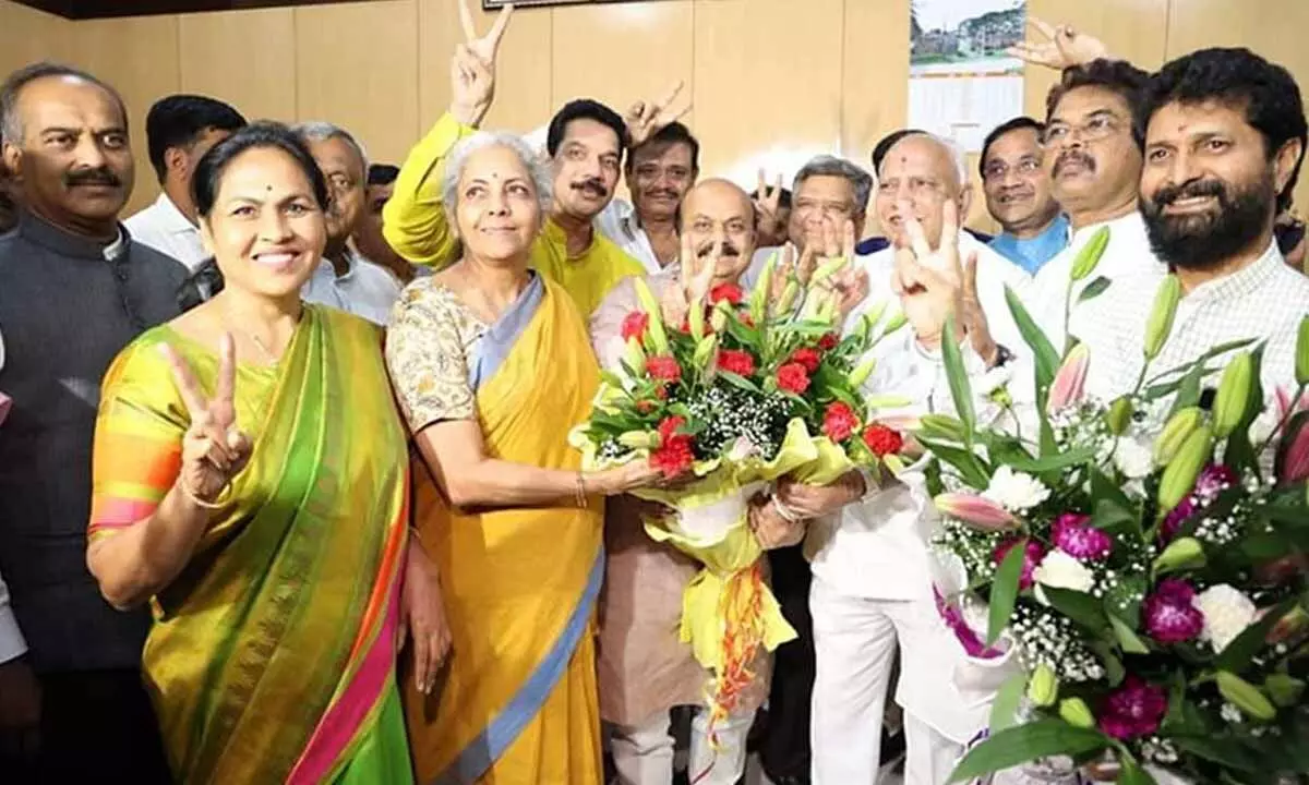 Nirmala Sitharaman being greeted by Chief Minister Basawaraj Bommai and Yediyurappa on her victory in Rajya Sabha election in Bengaluru on Saturday