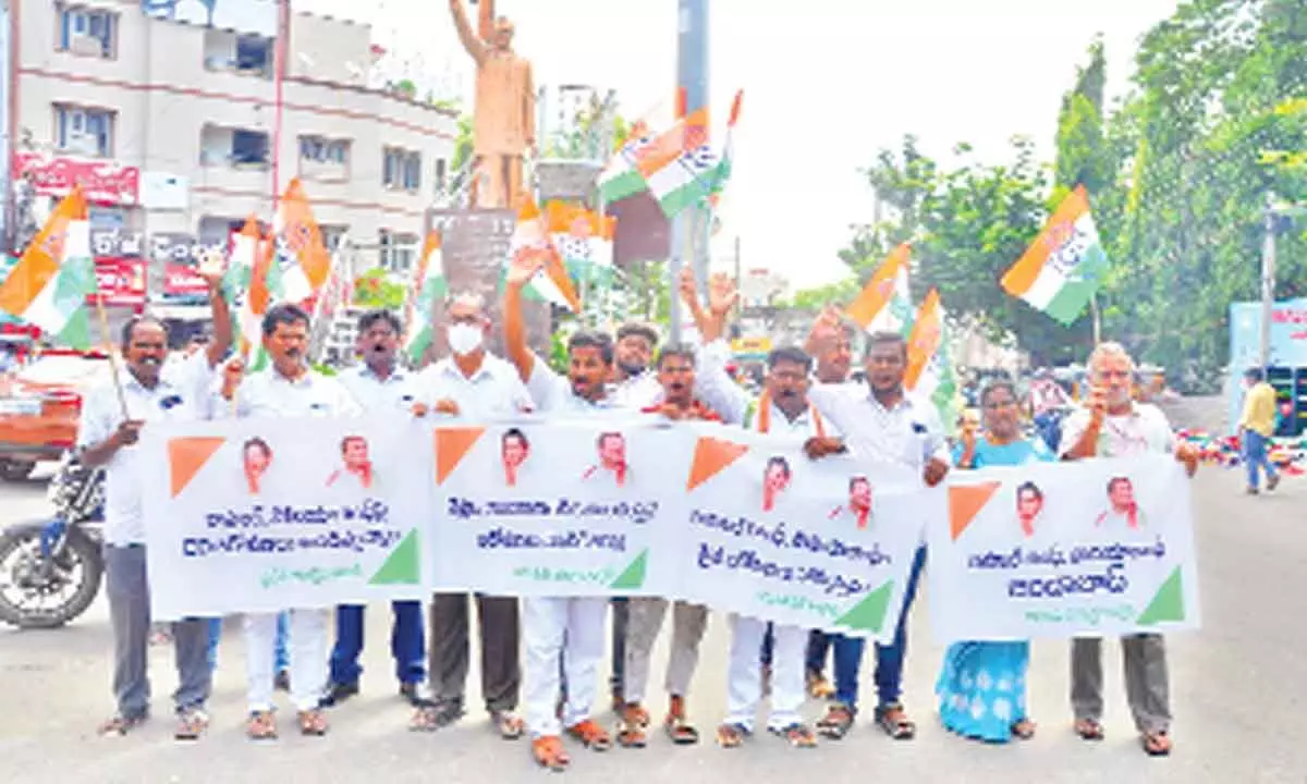 Congress leaders staging dharna at Rajiv Gandhi statue in Municipal Office Circle in Tirupati on Monday