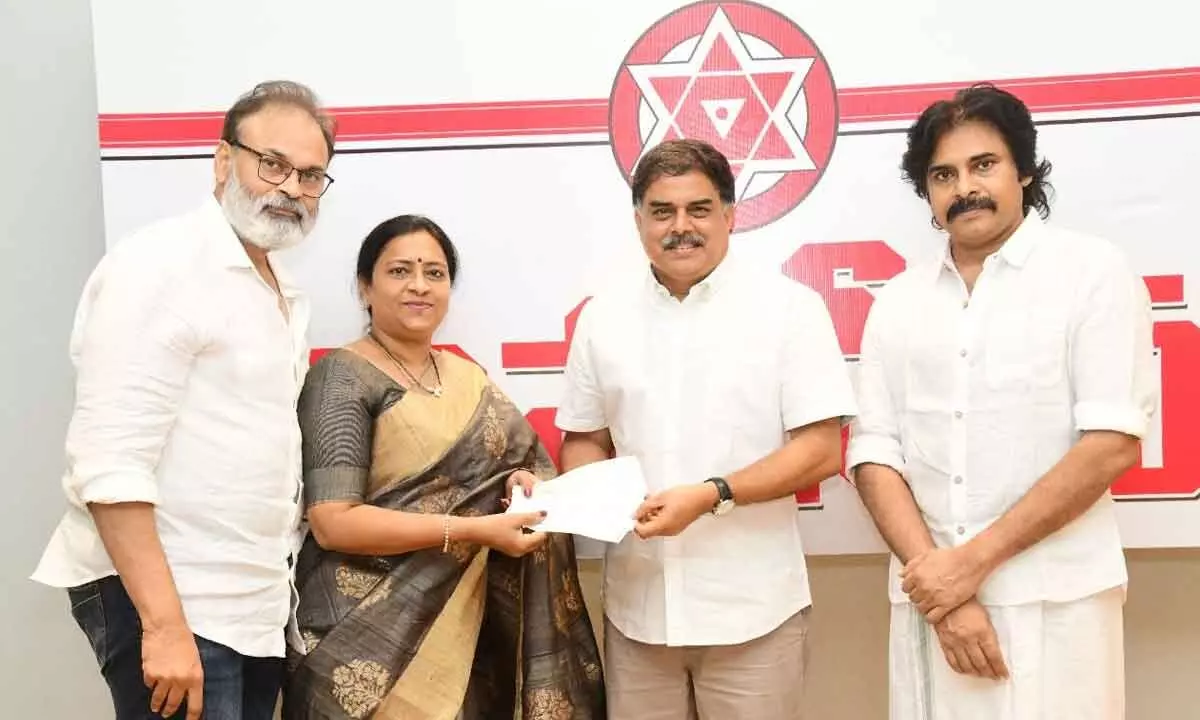 Nagababu couple hands over a chques for donation to Jana Sena Party political affairs committee chairman Nadendla Manohar at party state office in Mangalagiri on Monday. Party chief K Pawan Kalyan is also seen.
