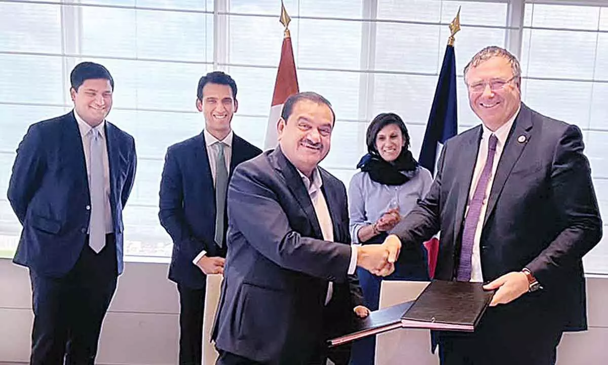 Chairman of Adani Group Gautam Adani and Chairman and CEO of Total Energies Patrick Pouyanné shake hands after signing an agreement to create the world’s largest green hydrogen ecosystem