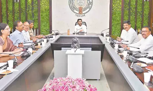 Chief Minister Y S Jagan Mohan Reddy reviews the job calendar at his camp office in Tadepalli on Friday