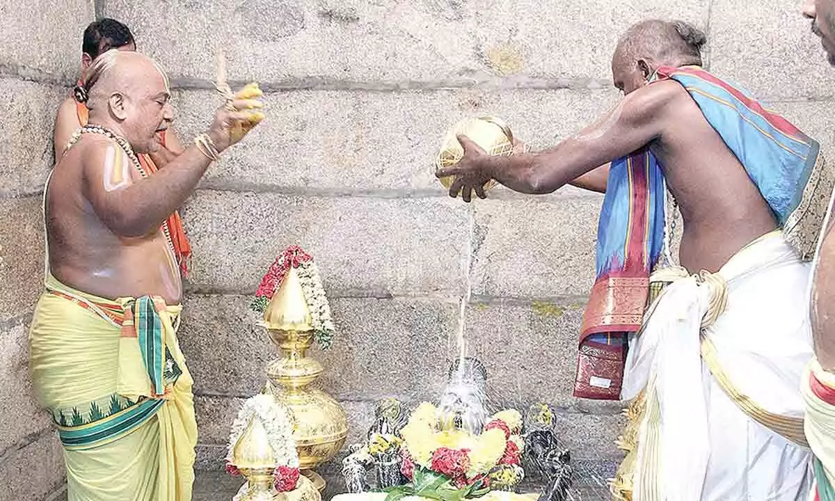 Priest performing Ksheeradhivasam ritual as part of Maha Samprokshanam in Vakulamatha temple at Pathakaluva village near Tirupati on Monday